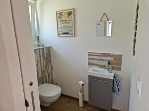 a bathroom with a toilet and a sink at Gite Bergamote in Champenoux +10 photos