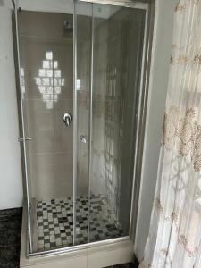a shower with a glass door in a bathroom at 85 Hidden Gem in Newlands +23 photos