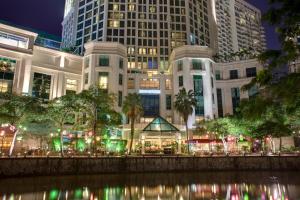 a view of a city at night with tall buildings at Grand Copthorne Waterfront in Singapore
