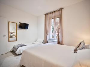 a bedroom with two beds and a window at Domus Pallium in Siena