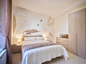 a bedroom with a bed and a wall with plants at Domus Pallium in Siena