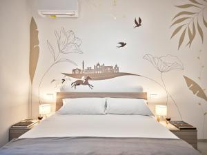 a bedroom with a bed with a mural on the wall at Domus Pallium in Siena