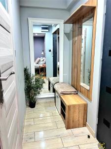 a hallway with a bench and a mirror at Apartament Pastelowy Tukan in Kwidzyn