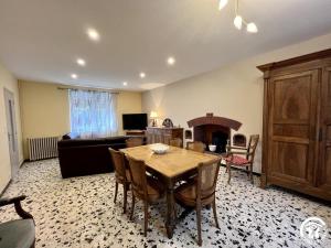 a living room with a dining room table and a couch at Peyret in Cépie