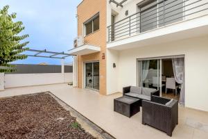 un patio d'une maison avec un canapé et une table dans l'établissement Bright & Airy 3BR Spacious Villa, à Sesimbra