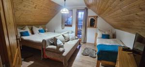 a bedroom with two beds and a couch in a room at Skiprivat in Ružomberok