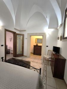 a bedroom with two beds and a room with a desk at Casa Naida in Nardò