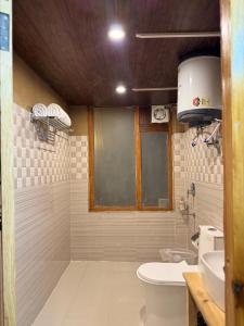 a bathroom with a toilet and a sink at Mountain Nest Stay in Jibhi +38 photos