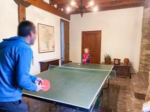 een man die voor een tafeltennistafel staat bij Casa Rural Masión de Egüés in Elcano +36 foto's
