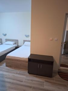 a bedroom with two beds and a mirror at LaRaMi Studio in Sveti Vlas +13 photos