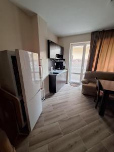 a room with a kitchen and a living room at LaRaMi Studio in Sveti Vlas