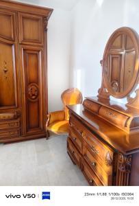a wooden dresser with a mirror on top of it at AR lodges in Montecosaro