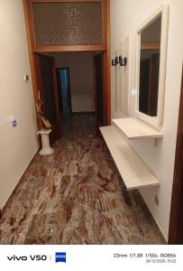 a hallway with a marble floor in a room at AR lodges in Montecosaro