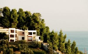 a house on top of a hill with trees at Sea Horizon Private Villa with Panoramic Sea Views in Nea Skioni