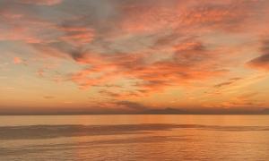 a sunset over the ocean with a cloudy sky at Sea Horizon Private Villa with Panoramic Sea Views in Nea Skioni