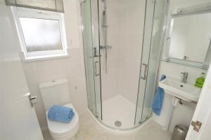 a bathroom with a shower and a toilet and a sink at 3 Bed in Gower oc-hh2105 in Rhossili +21 photos