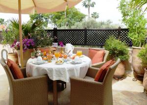 a table with a white table cloth on a patio at Riad Viva in Marrakesh