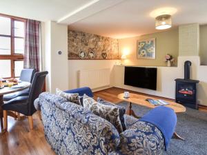 a living room with a couch and a table at 2 Bed in Godshill oc-ic072 in Godshill