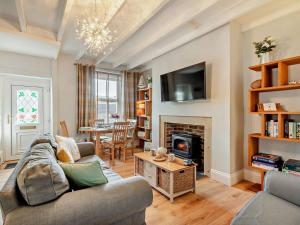 a living room with a couch and a fireplace at 2 Bed in Seahouses oc-cn082 in Seahouses