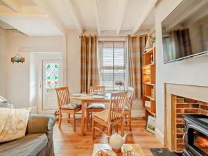 a living room with a table and a fireplace at 2 Bed in Seahouses oc-cn082 in Seahouses