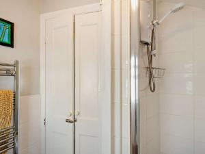 a shower with a white door in a bathroom at 2 Bed in Seahouses oc-cn082 in Seahouses +10 photos