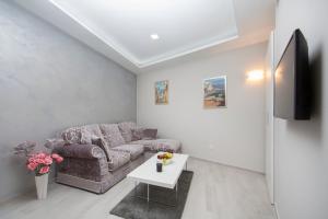 a living room with a couch and a table at Boutique Hotel Melissa in Poreč
