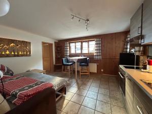 a room with a kitchen and a table with chairs at Sertig Ferienwohnung in Davos