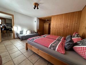 a bedroom with a bed and a living room at Sertig Ferienwohnung in Davos