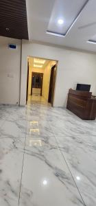 an empty room with marble floors and a hallway at Pratap Royal Stay in Ujjain
