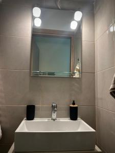 a bathroom with a white sink and a mirror at MINAS CENTRAL apartments in Heraklio +16 photos