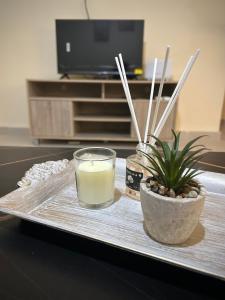 a tray with a glass of milk and a candle at MINAS CENTRAL apartments in Heraklio