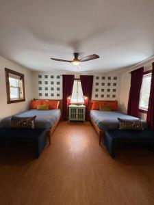 a bedroom with two beds and a ceiling fan at Powderhorn Hideaway in Auvinen Corner