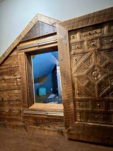 a mirror in the shape of a house at Powderhorn Hideaway in Auvinen Corner