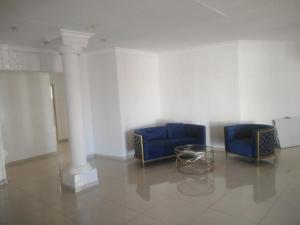 two blue chairs and a table in a room at Bafokeng Palace in Mid-Ennerdale