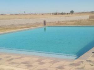 an empty swimming pool in the middle of the desert at Bafokeng Palace in Mid-Ennerdale