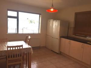 a kitchen with a table and a television and a table and chairs at Bunratty Star in Dublin +8 photos