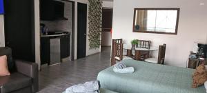 a living room with a couch and a table at SUITE EN TORRES GEMELAS a pie de playa 1403 N in Acapulco