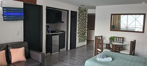 a living room and kitchen with a couch and a table at SUITE EN TORRES GEMELAS a pie de playa 1403 N in Acapulco