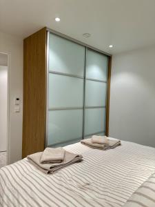 a bedroom with a bed with two towels on it at Tromso Panorama in Tromsø