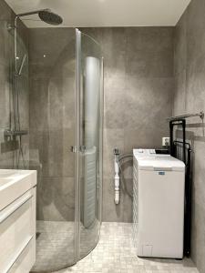 a bathroom with a shower and a toilet and a sink at Tromso Panorama in Tromsø +30 photos