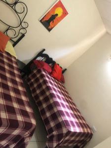 En eller flere senge i et værelse på Hospedaje Maluli 02