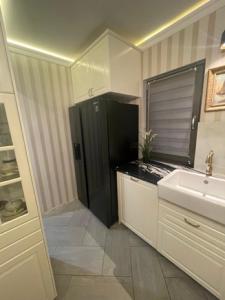 a kitchen with a black refrigerator and a sink at Dom Berry in Chrzanow +29 photos