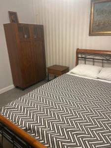 a bedroom with a bed and a dresser at Dom Berry in Chrzanow