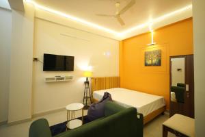 a hotel room with a bed and a tv at Buddha Premium Stays in Guwahati