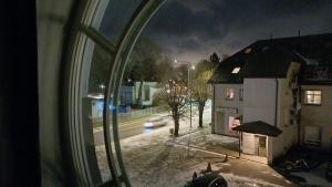 a view from a window of a street at night at Keila Round View Apartment in Keyla +4 photos