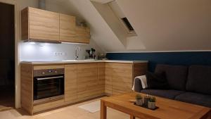 a living room with a couch and a kitchen at Keila Round View Apartment in Keyla