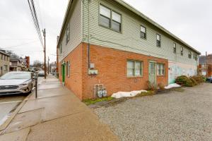 een gebouw in een straat met een auto ernaast bij Walk to Shops and Eats Apt in Downtown Elizabeth in Clairton