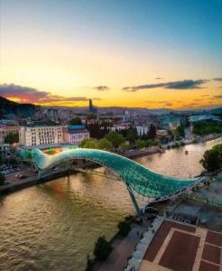 a bridge over a river in a city at Hotel Zaira in Tbilisi City +69 photos