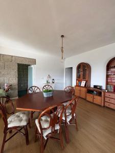 a living room with a wooden table and chairs at Refúgio da Serra - Cottage House in Fornos de Algodres