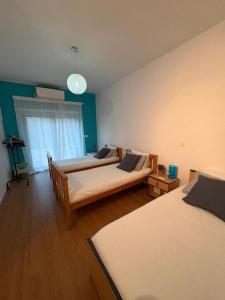 a bedroom with two beds and a chandelier at Refúgio da Serra - Cottage House in Fornos de Algodres